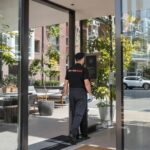 Professional cleaner entering Montreal apartment building, residential cleaning context
